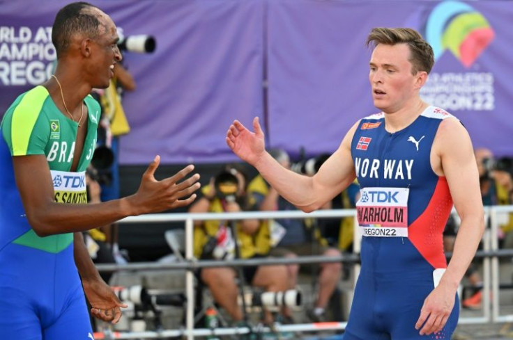 Gold medallist Brazil's Alison Dos Santos (L) shakes hands with Norway's Karsten Warholm