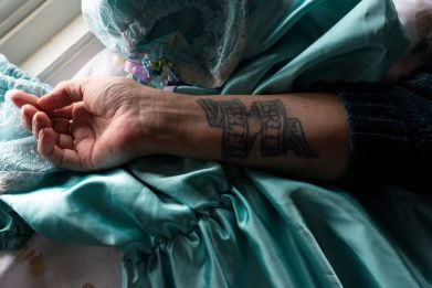 Dale Cook Driscoll shows her arm, tattooed with the names of her daughter, Helen Buchel, 34, and granddaughter, Brittany Passalacqua, 12, who were stabbed to death by Buchel's boyfriend, John Brown, in 2009, in Rochester, New York, U.S., February 11, 2020