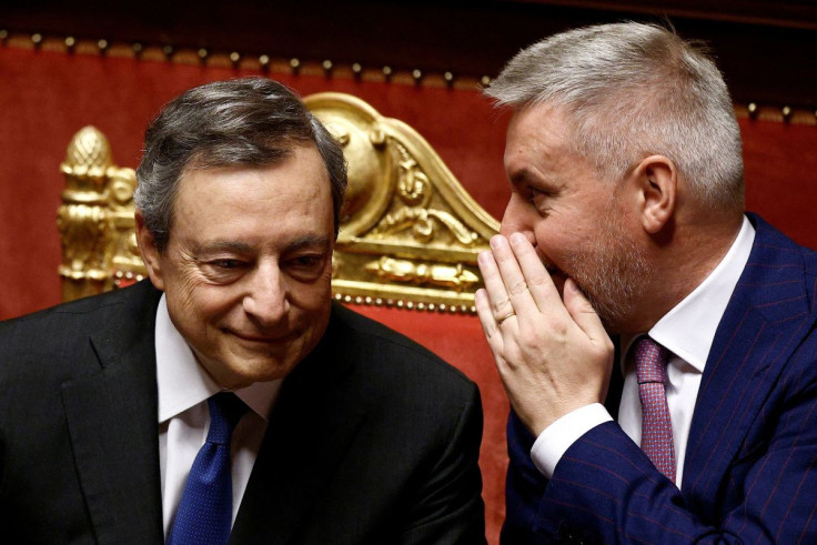 Italian Prime Minister Mario Draghi talks with Italian Defense Minister Lorenzo Guerini before his address to the Senate ahead of a confidence vote for the government after he tendered his resignation last week in the wake of a mutiny by a coalition partn