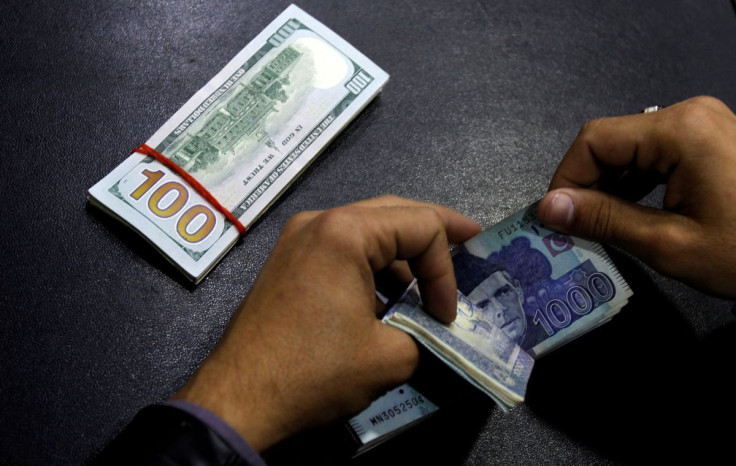 A currency trader counts Pakistani Rupee notes as he prepares an exchange of U.S dollars in Islamabad, Pakistan December 11,  2017.  