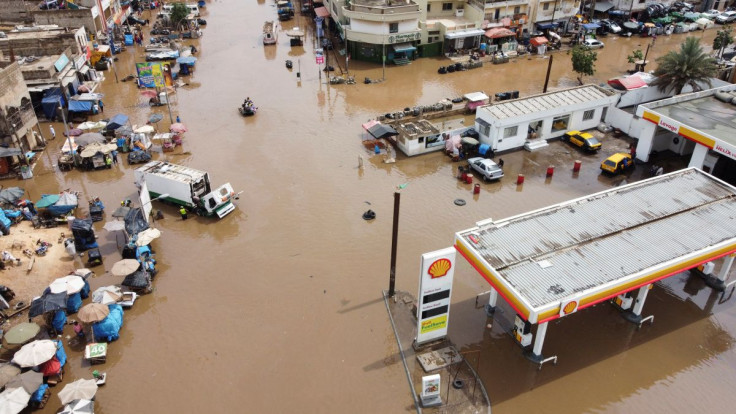An aerial view shows residents making their way through a flooded street after heavy rains in Yoff district of Dakar, Senegal July 20, 2022.