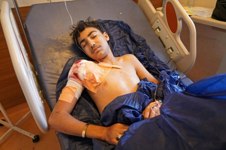 An injured man lies on a hospital bed following the shelling on Wednesday