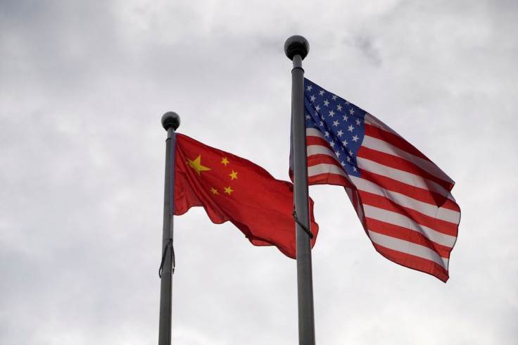 Chinese and U.S. flags flutter outside a company building in Shanghai, China November 16, 2021. 