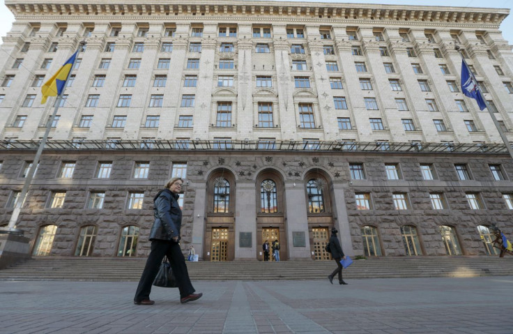 Women walk in a front of the city council in Kiev, Ukraine, October 8, 2015. 