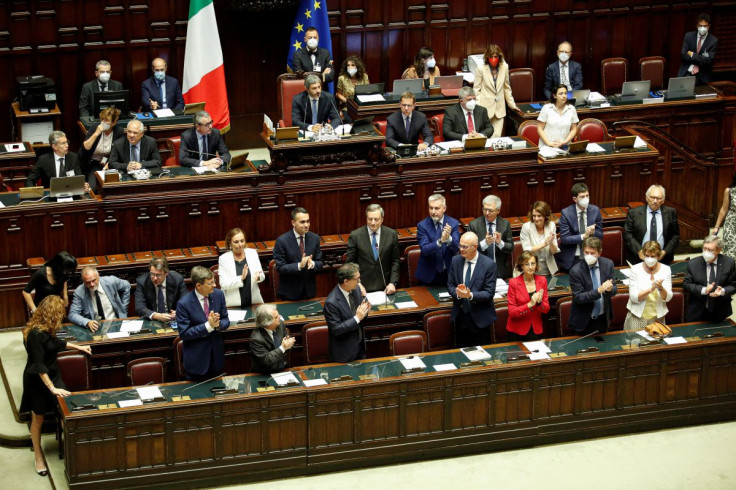 Attendees applaud Italy's Prime Minister Mario Draghi as he arrives to address the lower house of parliament ahead of a vote of confidence for the government after he tendered his resignation last week in the wake of a mutiny by a coalition partner, in Ro