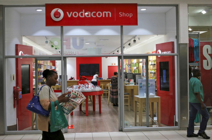 A shopper walks past a Vodacom shop in Johannesburg February 4, 2015.