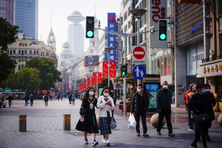 People wearing face masks walk at a main shopping area, following the coronavirus disease (COVID-19) outbreak in Shanghai, China January 27, 2021. 