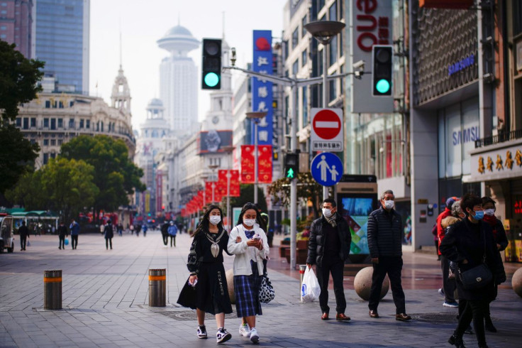 People wearing face masks walk at a main shopping area, following the coronavirus disease (COVID-19) outbreak in Shanghai, China January 27, 2021.