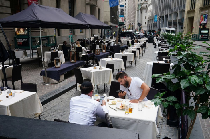 People eat at a mostly empty restaurant with tables on the street, in the financial district during the coronavirus disease (COVID-19) pandemic in the Manhattan borough of New York City, New York, U.S., September 9, 2020.  