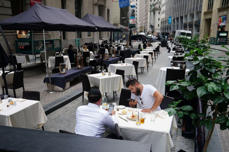 People eat at a mostly empty restaurant with tables on the street, in the financial district during the coronavirus disease (COVID-19) pandemic in the Manhattan borough of New York City, New York, U.S., September 9, 2020.