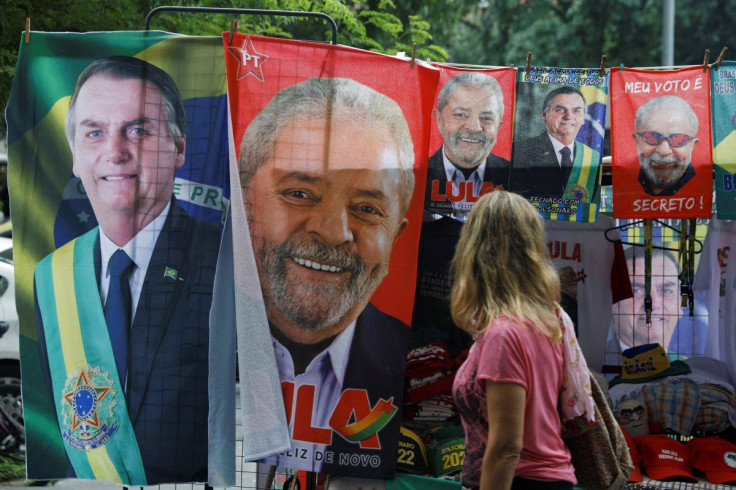 A woman looks at displayed towels and presidential campaign materials depicting Brazil's former President Luiz Inacio Lula da Silva and Brazil's President Jair Bolsonaro, in Rio de Janeiro, Brazil, July 20, 2022. 