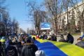 Live-streamed footage shows people carrying a banner in the colours of the Ukrainian flag as they protest amid Russia's invasion of Ukraine, in Kherson, Ukraine, March 13, 2022 in this still image from a social media video obtained by REUTERS