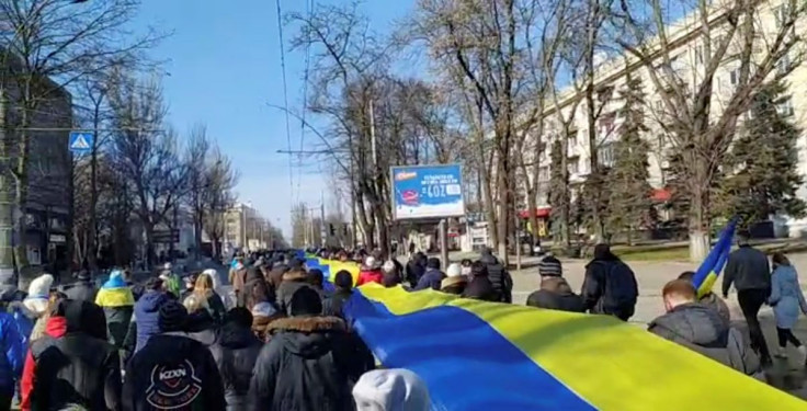 Live-streamed footage shows people carrying a banner in the colours of the Ukrainian flag as they protest amid Russia's invasion of Ukraine, in Kherson, Ukraine, March 13, 2022 in this still image from a social media video obtained by REUTERS