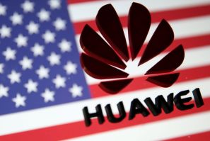 A 3D printed Huawei logo is placed on glass above displayed US flag in this illustration taken January 29, 2019. 