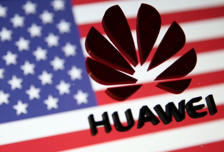 A 3D printed Huawei logo is placed on glass above displayed US flag in this illustration taken January 29, 2019. 