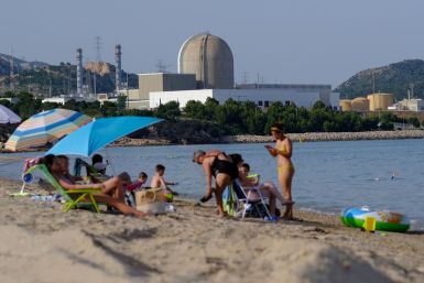 The Vandellos II Nuclear Power Plant is pictured as people enjoy the weather at Almadraba beach in Hospitalet del Infante, as a heatwave hits Spain, June 17, 2022. 