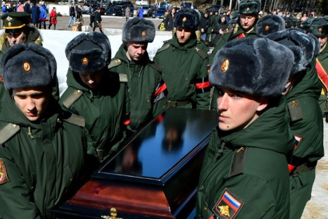 Soldiers carry the coffin of 20-year-old Russian serviceman Nikita Avrov, during his funeral at a church in Luga, some 150 kilometers south of Saint Petersburg, on April 11, 2022