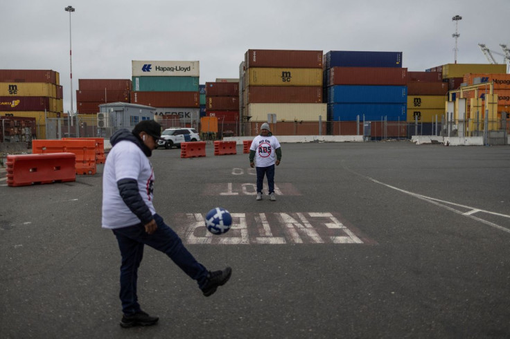 Truck drivers play soccer as they join a gathering to block the entrance of trucks at a container terminal at the Port of Oakland, during a protest against California's law known as AB5, in Oakland, California, July 21, 2022.