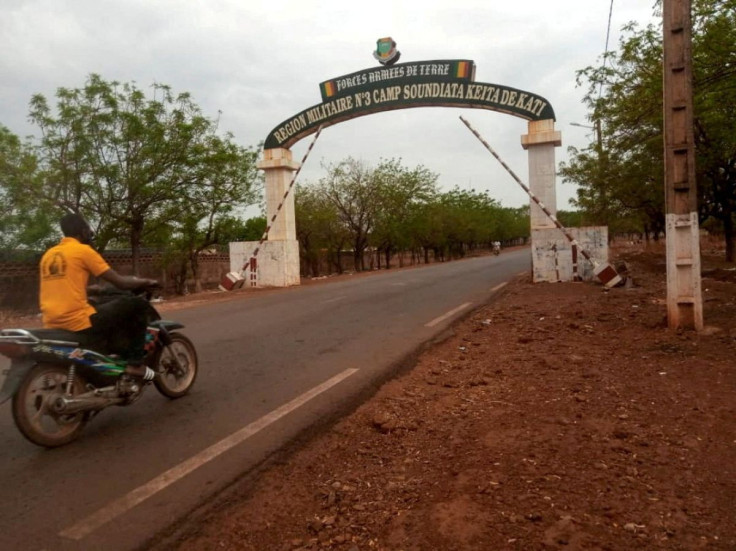 A man rides a motorcycle as he drives past the entrance of the Malian army force base in Kati, Mali May 25, 2021.