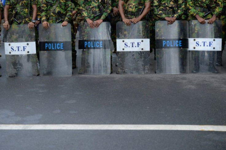 Police special task force personnel stand guard as demonstrators (not pictured) take part in a protest march against Sri Lankan President Ranil Wickremesinghe