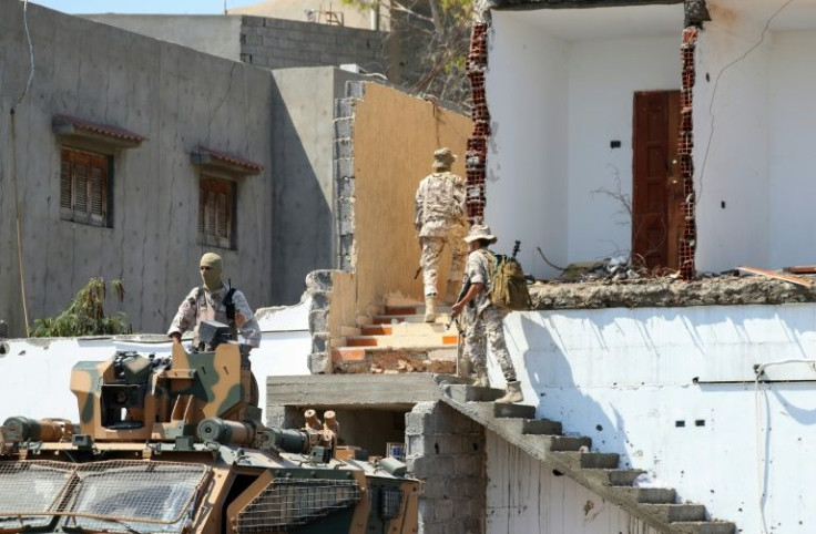 Members of the 444 Brigade take up positions after fighting between two militias nominally loyal to Abdulhamid Dbeibah's Government of National Unity