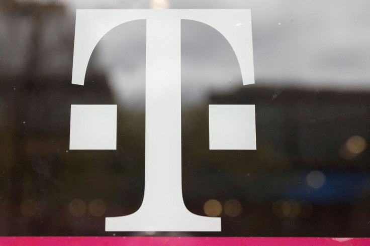 A T-Mobile logo is seen on the storefront door of a store in Manhattan, New York, U.S., April 30, 2018. 