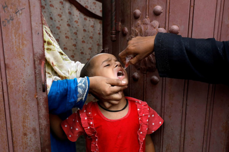 A girl receives polio vaccine drops, during an anti-polio campaign, in a low-income neighborhood as the spread of the coronavirus disease (COVID-19) continues, in Karachi, Pakistan July 20, 2020. 