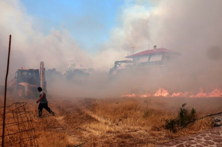 Firefighters are battling the surging blaze in the popular resort of Vatera on the Greek island of Lesbos
