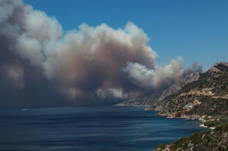 At least two houses were ravaged by the fire on the island of Lesbos, state TV ERT said