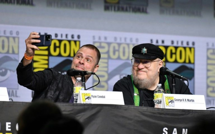 Screenwriter Ryan Condal and author George RR Martin take a selfie onstage at the HBO "House of the Dragon" panel during Comic-Con International in San Diego, California, July 23, 2022