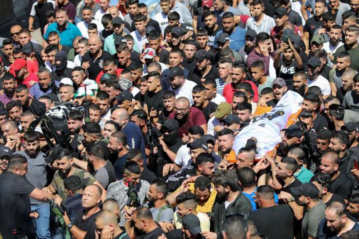 Mourners carry the bodies of two Palestinian militants who were killed by Israeli forces in a gun battle, during their funeral in Nablus in the Israel-occupied West Bank July 24, 2022.