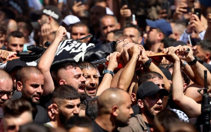 Mourners carry the body of one of two Palestinians killed overnight in confrontations with Israeli troops in the the occupied West Bank city of Nablus