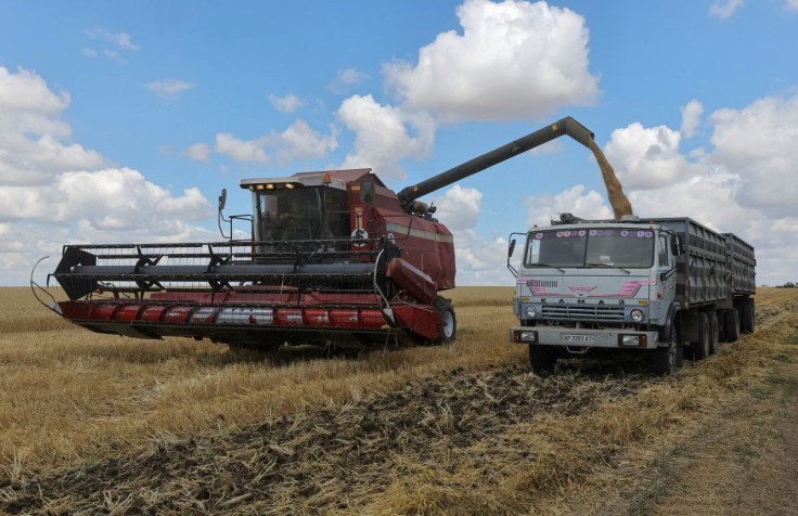 A combine loads wheat in Russian-held part of Zaporizhzhia region, Ukraine July 23, 2022.