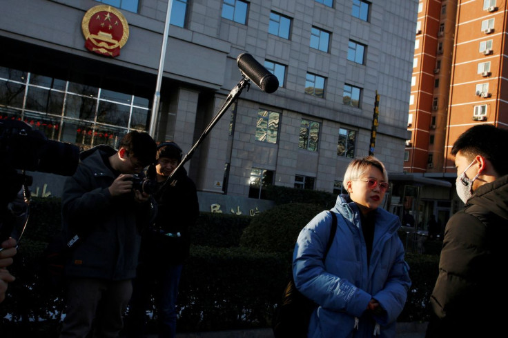 Teresa Xu, 31, talks to a supporter outside Chaoyang People's Court before a court hearing of her suit against a Beijing hospital for rejecting her request to freeze her eggs as an unmarried woman, in Beijing, China December 23, 2019.