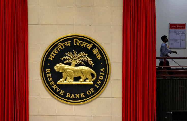 A worker walks past the logo of Reserve Bank of India (RBI) inside its office in New Delhi, India July 8, 2019.