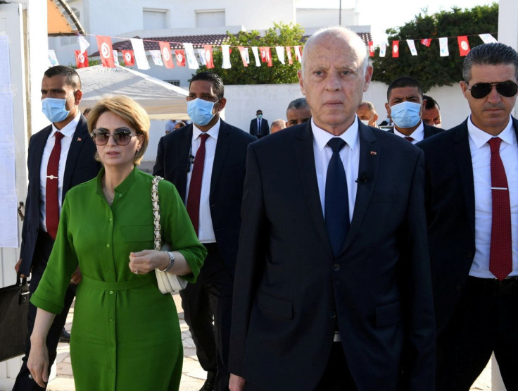 Tunisia's President Kais Saied and his wife Ichraf Chebil walk outside a polling station, during a referendum on a new constitution in Tunis, Tunisia July 25, 2022. Tunisian Presidency/Handout via REUTERS