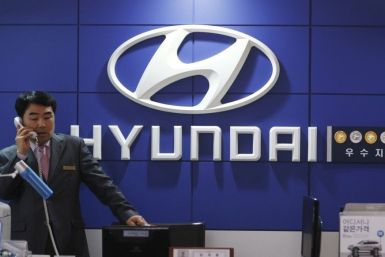 A salesman talks on a phone at a Hyundai Motor dealership in Seoul April 28, 2011.