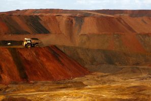 A truck carrying iron ore moves along a road at the Fortescue Metals Group (FMG) Christmas Creek iron ore mine located south of Port Hedland in the Pilbara region of Western Australia, November 17, 2015.  Picture taken November 17, 2015.    