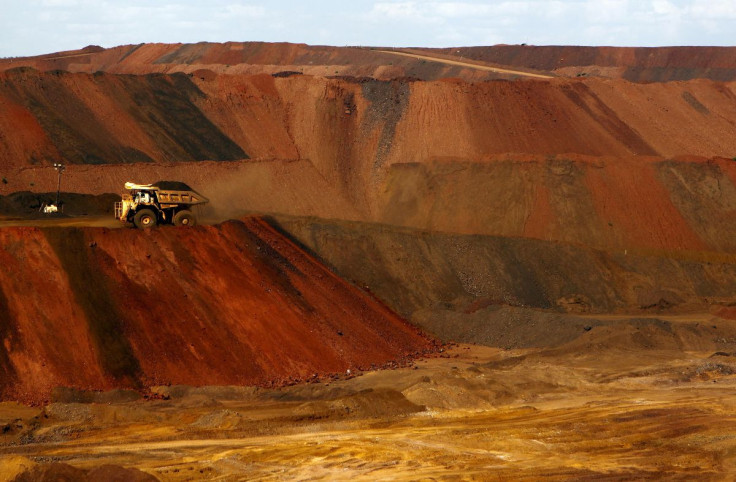 A truck carrying iron ore moves along a road at the Fortescue Metals Group (FMG) Christmas Creek iron ore mine located south of Port Hedland in the Pilbara region of Western Australia, November 17, 2015.  Picture taken November 17, 2015.    