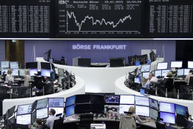 Traders are pictured at their desks in front of the DAX board at the stock exchange in Frankfurt, Germany July 29, 2015. Global stock markets have lost ground over the last month, due to concerns over China's economy and Greece's debt crisis, but a stabil
