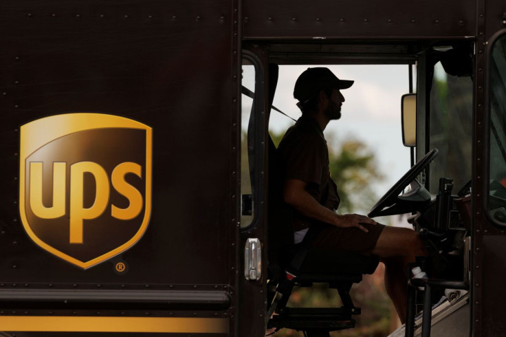 A UPS delivery van is driven long a city street in Garden Grove, California, U.S., March 29, 2022.   
