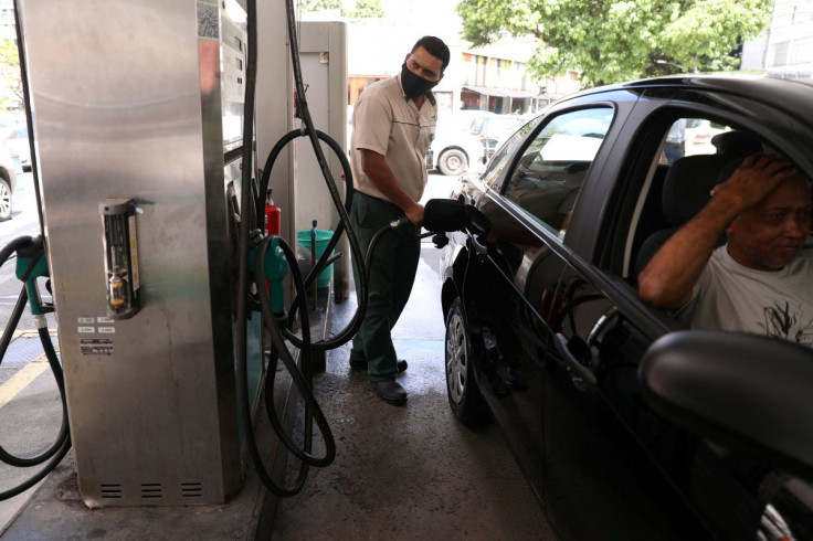 A worker pumps a car with gasoline at a gas station in Rio de Janeiro, Brazil March 10, 2021.