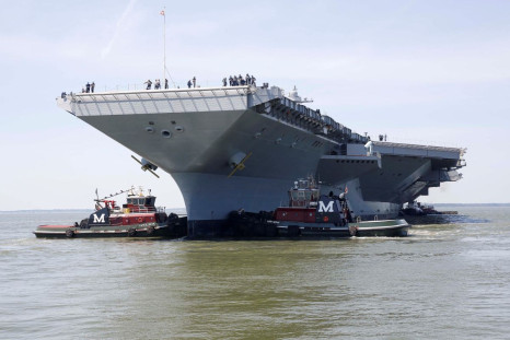 Pre-Commissioning Unit Gerald R. Ford (CVN 78) is maneuvered by tug boats in the James River during the aircraft carrier's turn ship evolution in Newport News, Virginia, U.S. June 11, 2016. U.S. Navy/Mass Communication Specialist Seaman Apprentice Gitte S