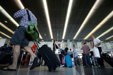 Passengers make their way through a terminal at O'Hare International Airport in Chicago, Illinois, September 26, 2014. 