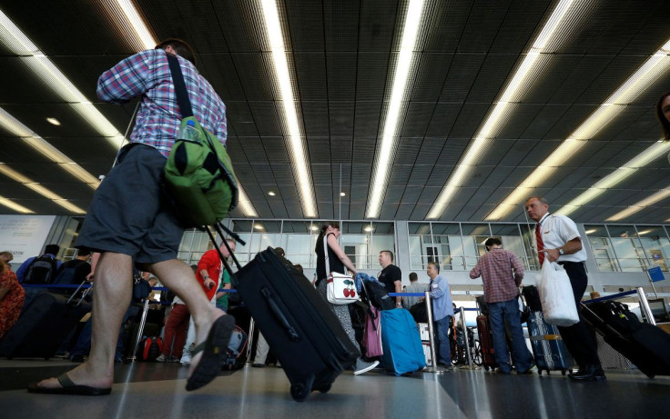 Passengers make their way through a terminal at O'Hare International Airport in Chicago, Illinois, September 26, 2014. 