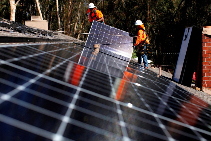 Solar installers from Baker Electric place solar panels on the roof of a residential home in Scripps Ranch, San Diego, California, U.S. October 14, 2016. 