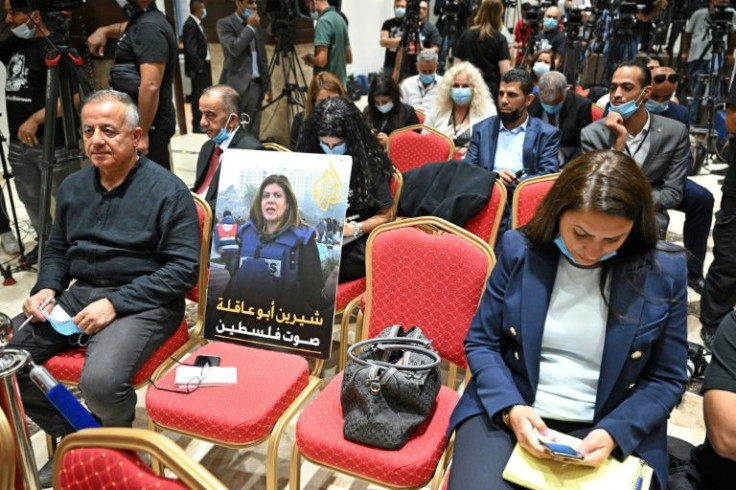 A photo of slain US-Palestinian Al Jazeera correspondent Shireen Abu Akleh is seen among reporters ahead of a joint press conference between the US and Palestinian presidents in Bethlehem on July 15, 2022
