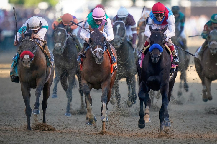 Medina Spirit, ridden by John Velazquez, right, crosses the finish line to win the 147th Kentucky Derby in Louisville, Kentucky, U.S. May 1, 2021.