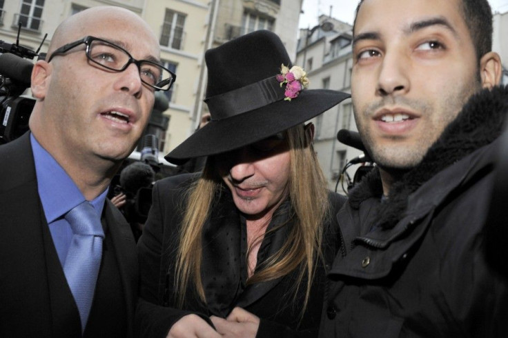 Fashion designer Galliano and his lawyer Zerbib arrive for a hearing at a police station in Paris