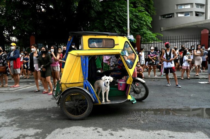 Residents evacuate a building after a 7.1 magnitude earthquake, some 300 kilometers away, was felt in Manila